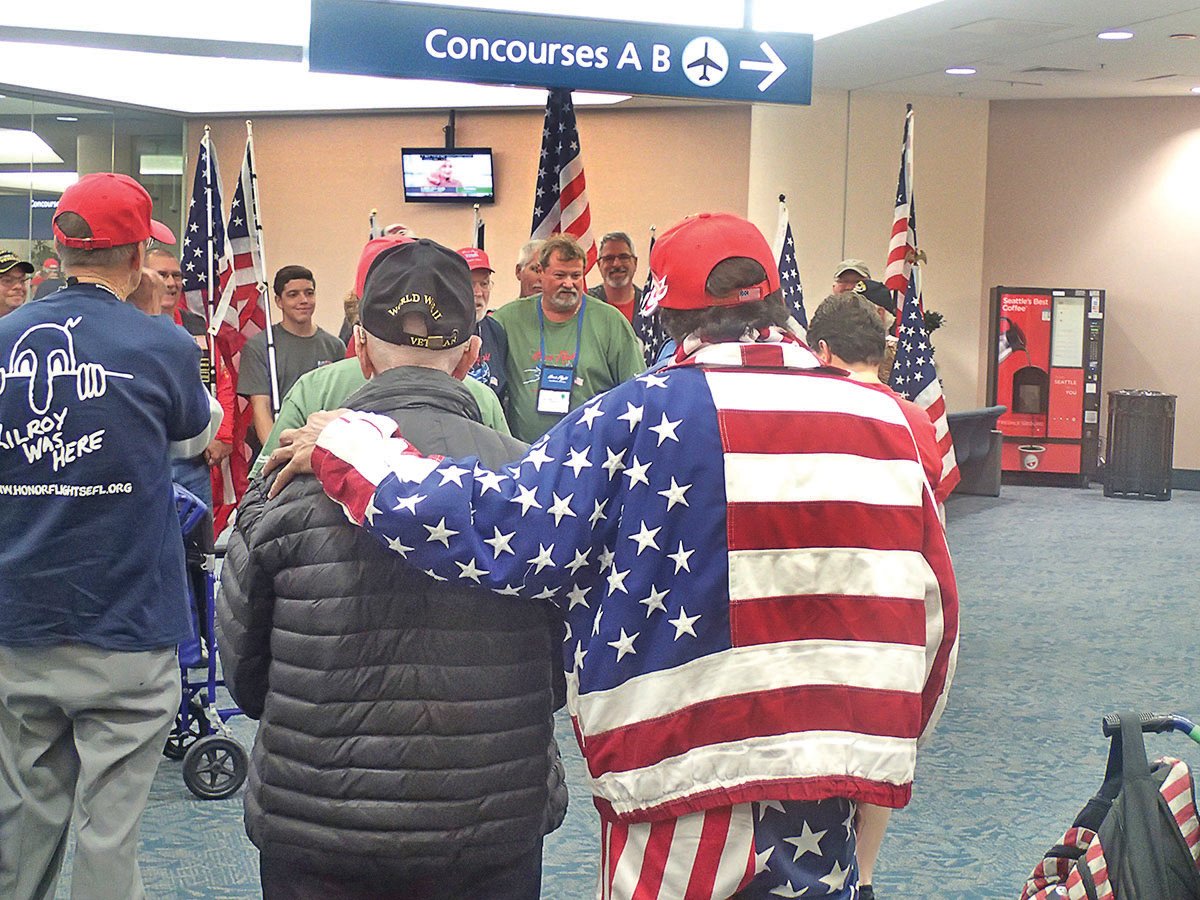 This is a photo of veterans being welcomed home from a previous Honor Flight mission.